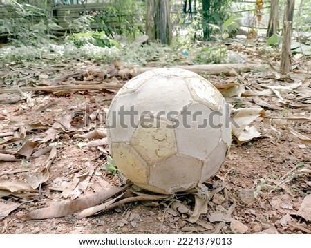 old balls are often used to play soccer. old ball close up