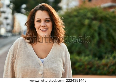 Young irish plus size girl smiling happy standing at the city. Royalty-Free Stock Photo #2224381443