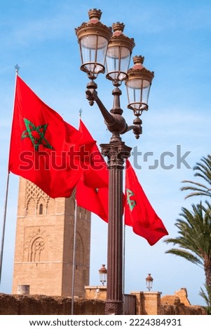Moroccan flags fluttering and the Hassan tower in the background in Rabat