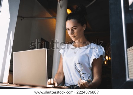 Attractive woman searching web publication while networking browser on modern laptop technology, skilled female programmer working remotely on digital netbook device - using 4g wireless connection