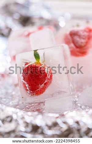 fresh strawberry in ice cube