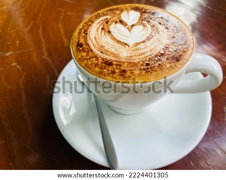 A cup of hot coffee on the wooden table with the light of sun, it’s the good first thing after wake up in the morning for starting a good day. Make feeling fresh and relax with a smell and taste good.