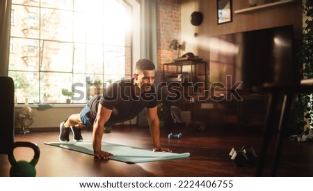 Strong Athletic Black Man Does Workout at Home Gym, Doing Push Ups. Lean Fit Muscular Mixed Race Sportsman Staying Healthy, Training at Home. Sweat and Determination. Wide Shot Royalty-Free Stock Photo #2224406755
