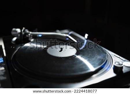 Dj turntable playing vinyl record with music on hip hop party. Professional analog turn table player for disc jockey. Download stock photo of retro disk jokey audio equipment
