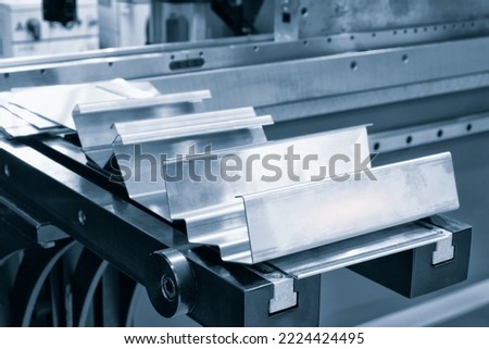 Metal products bent on a bending machine. Factory made products. Industrial concept background. Royalty-Free Stock Photo #2224424495