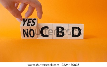 Yes or No CBD symbol. Businessman hand turns wooden cube and changes words No CBD to Yes CBD. Beautiful orange background. Business and Yes or No CBD concept. Copy space.