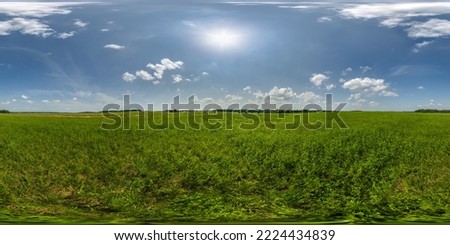 full seamless 360 hdri panorama view among farming field with sun and clouds in overcast sky in equirectangular spherical projection, ready for use as sky replacement in drone panoramas or VR content Royalty-Free Stock Photo #2224434839
