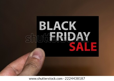 Hand holding a Black Friday ticket