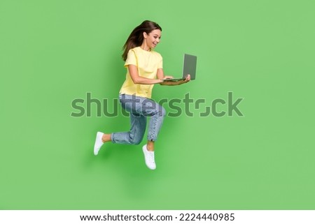 Full length photo of positive lady hold enjoy rejoice buy modern device low price sale run empty space isolated on green color background