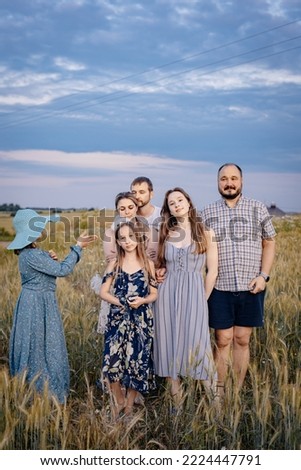 The whole family met in the village for a beautiful family photo on the field at sunset for the album. Escorting the family in the evening at sunset