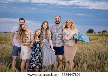 The whole family met in the village for a beautiful family photo on the field at sunset for the album. Escorting the family in the evening at sunset