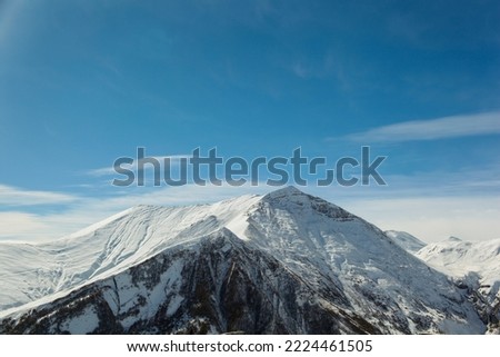 Snowy mountain peaks under a blue sky