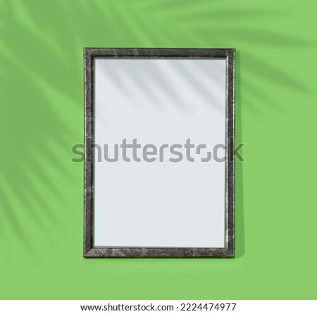 Green wooden frame on  monochrome background. Simple mockup for design. Copy space for  your text.