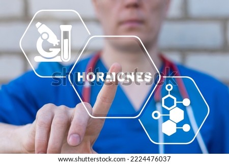 Doctor using virtual touchscreen presses word: HORMONES. Concept of hormone balance. Hormonal therapy. Hormones treatment medical innovation. Royalty-Free Stock Photo #2224476037