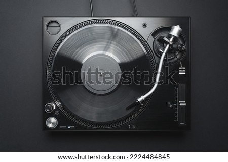 Dj turntable in flay lay. Vinyl record player shot directly from above on black background  Royalty-Free Stock Photo #2224484845