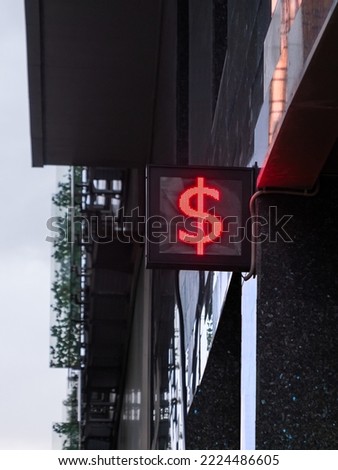 Symbol of USD, Dollar, currency of USA on outdoor electric screen. Currency exchange office or bank branch in downtown.