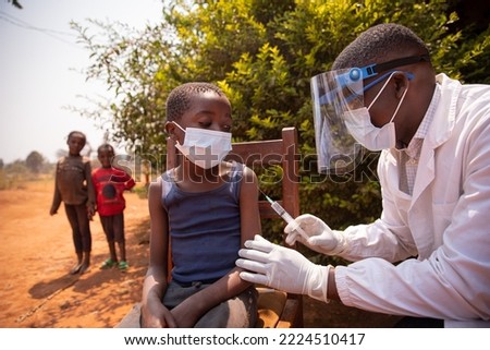 Open air vaccination session in an african village during corona virus pandemic. Royalty-Free Stock Photo #2224510417