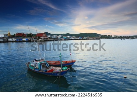 Fishing boats floating in the Sattahip Sea with the background of the market and Wat Sattahip.
Chonburi ,Thailand 