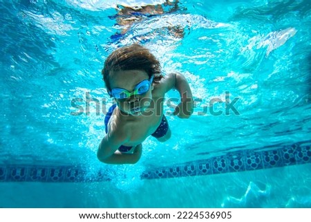 Underwater Young Boy Fun in the Swimming Pool with Goggles. Summer Vacation Fun.	 Royalty-Free Stock Photo #2224536905