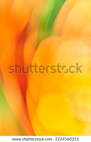 Artistic abstract colorful background in vivid colors, yellow, orange and green. Smooth and flowing design, energetic and vibrant.