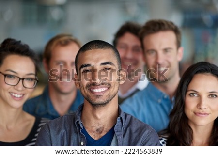 Feeling proud of our achievments. Shot of a smiling group of coworkers standing in an office. Royalty-Free Stock Photo #2224563889