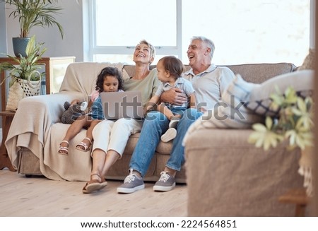 Happy, family and laptop on the sofa with children and grandparents on home sofa. Senior man and woman relax online with their adopted grandchildren while watching funny movie, streaming or cartoon