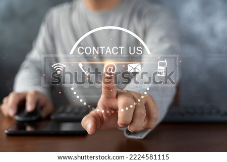 Contact us or Customer support hotline people connect. Businessman using a laptop and touching on virtual screen contact icons ( email, address, live chat, internet wifi ).