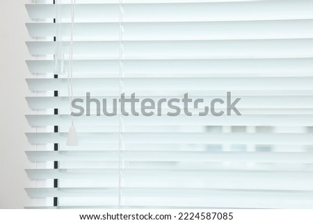 Closeup view of stylish horizontal window blinds Royalty-Free Stock Photo #2224587085