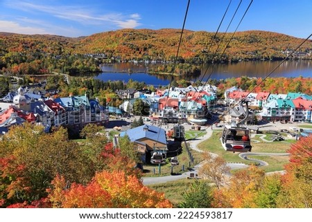 Lake and Mont Tremblant resort in autumn with cable car on the foreground, Canada