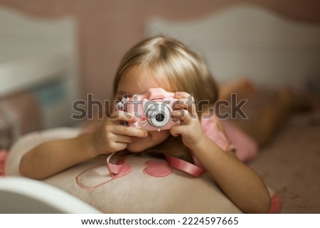 little girl taking pictures with her camera