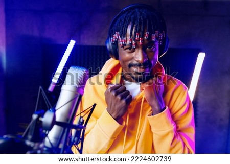 Young African performer recording his new track in recording studio