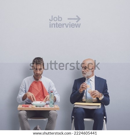 Candidates waiting for the job interview: one is eating a snack and the other is having lunch