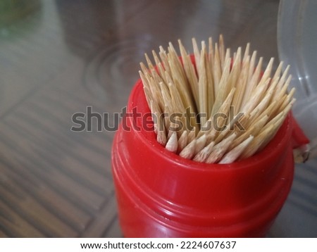 Toothpicks made of wood with a glass table baghround.
