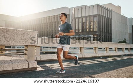 Fitness, health and city man running on street with motivation, healthy mindset and summer morning energy for training. Urban workout, cardio exercise and runner on bridge, focus on sports lifestyle.