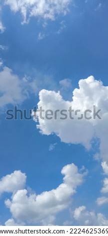 Beautiful white full clouds on deep blue sky background. Elegant blue sky picture in daylight. Big soft white clouds in the blue sky background. Cumulus clouds in clear blue sky. No focus