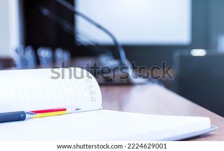 Notebooks with pencil and pen on the table in the meeting room
