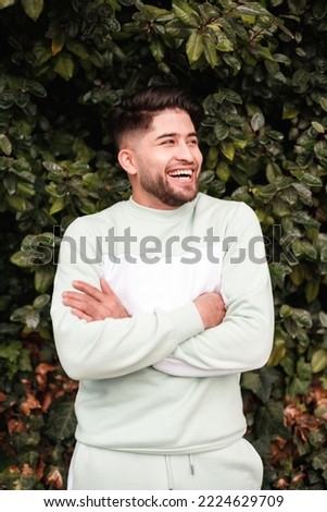 laughing young latin man in sportswear , vertical portrait Royalty-Free Stock Photo #2224629709