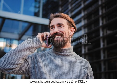 Portrait of young smiling cheerful entrepreneur man making phone call, having conversation talking to someone. High quality photo Royalty-Free Stock Photo #2224643217