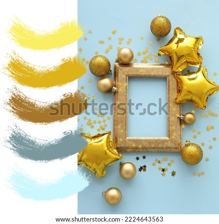 Composition with photo frame and Christmas decor on light blue background. Different color patterns