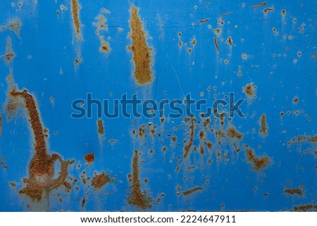 Cracked blue painted old metal texture with rusted surface