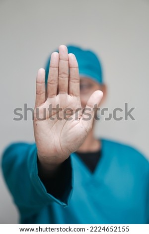 A man gesturing a hand showing five fingers meaning stop and warning to do not do something