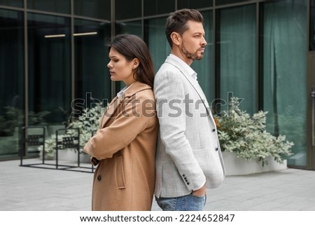 Upset arguing couple near building outdoors. Relationship problems Royalty-Free Stock Photo #2224652847