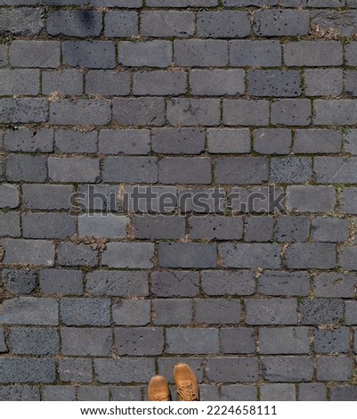Old paving slabs with shoes