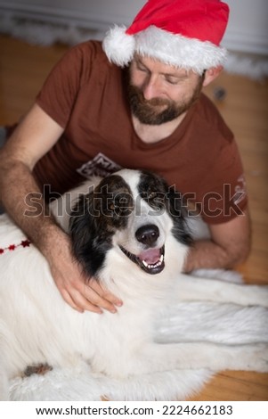 man with white dog at home at Christmas