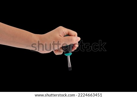 Screwdriver tools in hand on black background