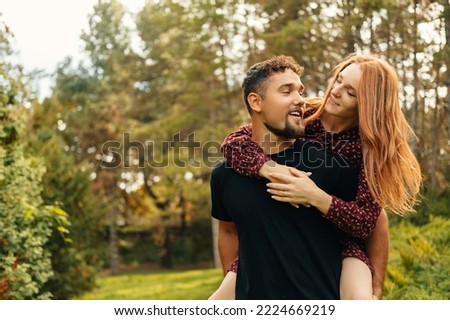 Happy romantic young couple embracing outdoor in nature and having beautiful time together.