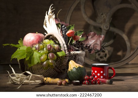 Picturesque autumn composition with  basket, fruits, pumpkin, mu