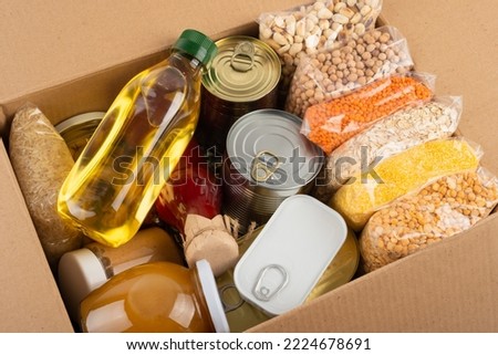 Survival set of nonperishable foods in carton box Royalty-Free Stock Photo #2224678691