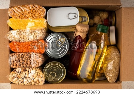Survival set of nonperishable foods in carton box Royalty-Free Stock Photo #2224678693