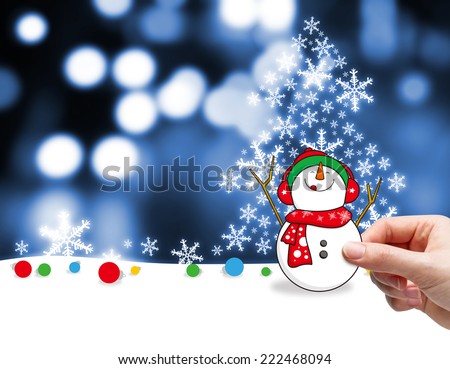 Christmas decoration of young woman hand holding snowman